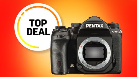 A Pentax K-1 II DSLR camera is featured against a vibrant orange background, highlighted by a "Top Deal" badge