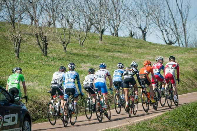 A break fights their way up a steep climb.