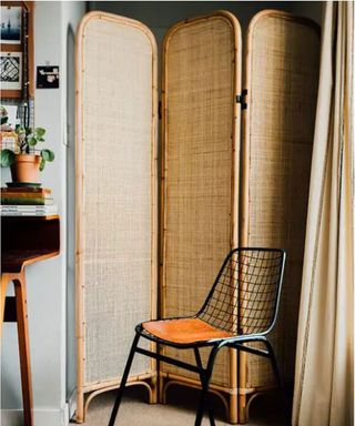 rustic natural rattan style folding room divider in a bedroom