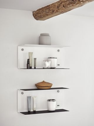 Four minimal bracket shelves by Vipp in the bathroom
