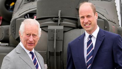 King Charles and Prince William pose while wears matching blue, red and white ties