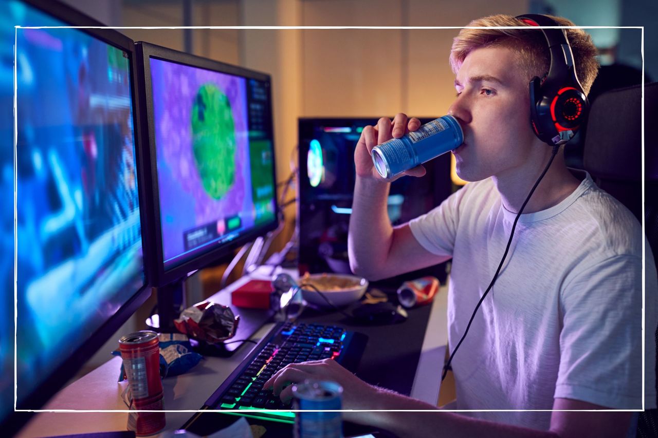 A teenage boy sips on a caffeine energy drink while gaming in his bedroom