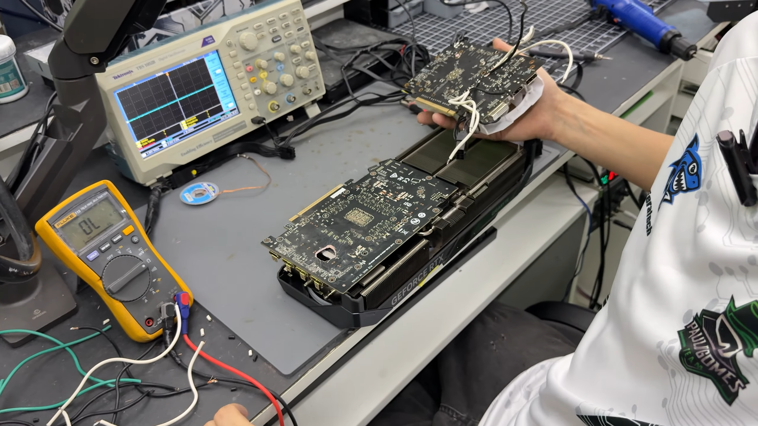 Dead RTX 5070 Ti with a hole burnt through its PCB