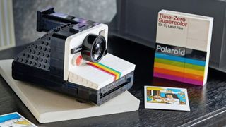 Lego Polaroid instant camera build completed and on a grey table