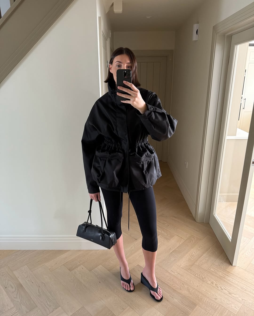 Influencer wearing capri trousers and a rain coat