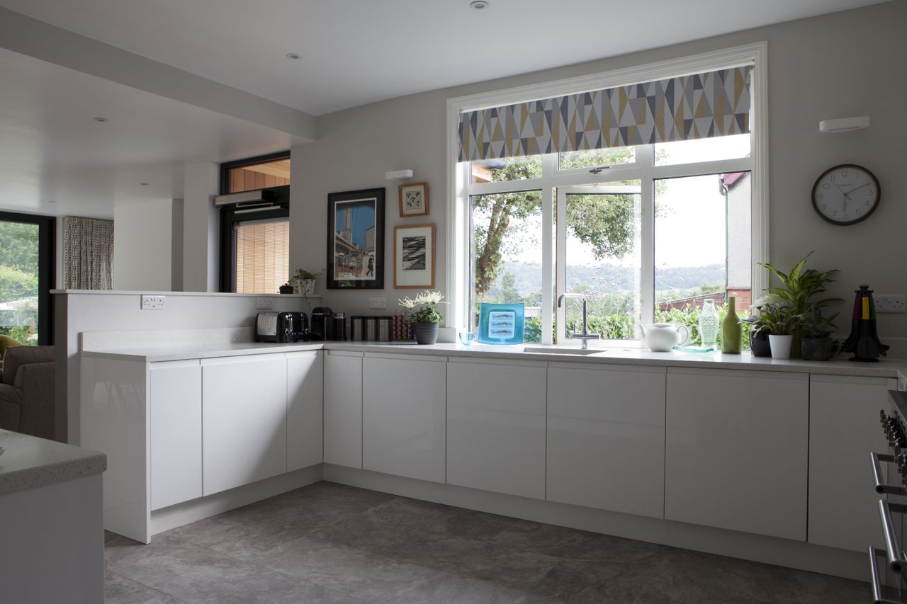 The white handleless kitchen (from 1st Class Kitchens) replaces the old dining room and now sits at the heart of the newly expanded home.