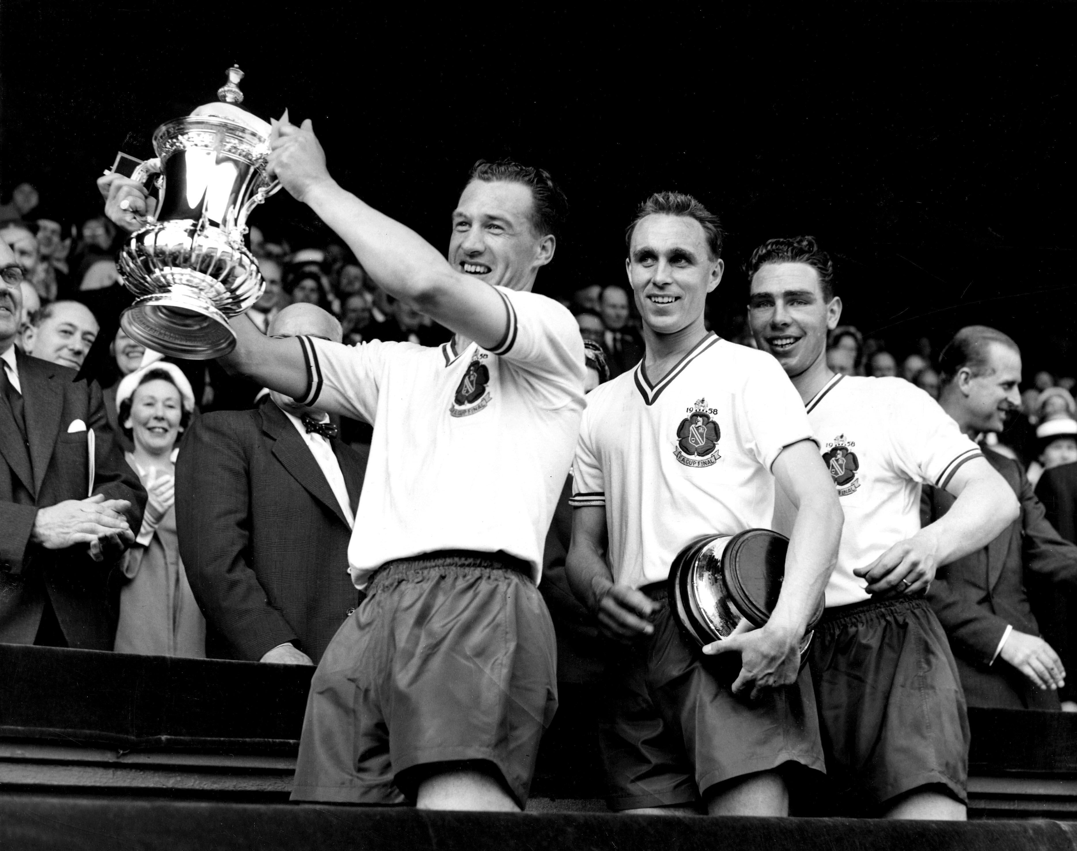 Bolton captain Nat Lofthouse lifts the FA Cup after victory over Manchester United in the 1958 final at Wembley