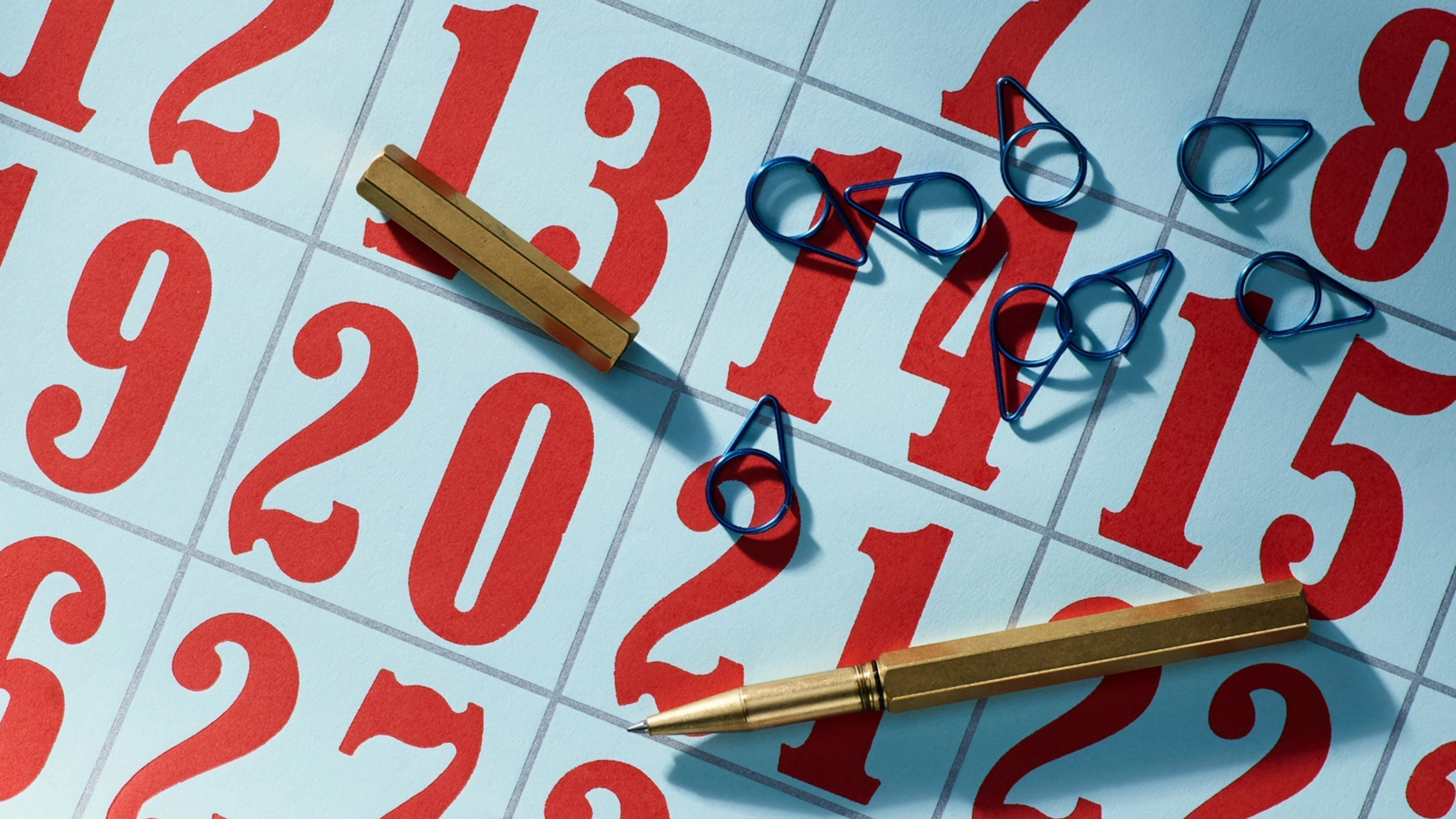Pen and paperclips on calendar, illustrating R Finds back to business desktop shopping guide