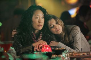 Sandra Oh and Ellen Pompeo hugging at a bar in Grey's Anatomy