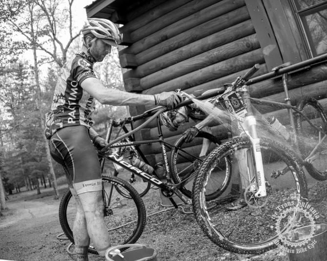 Matthew Ferrari washes his bike after a damp and grimy day of racing.