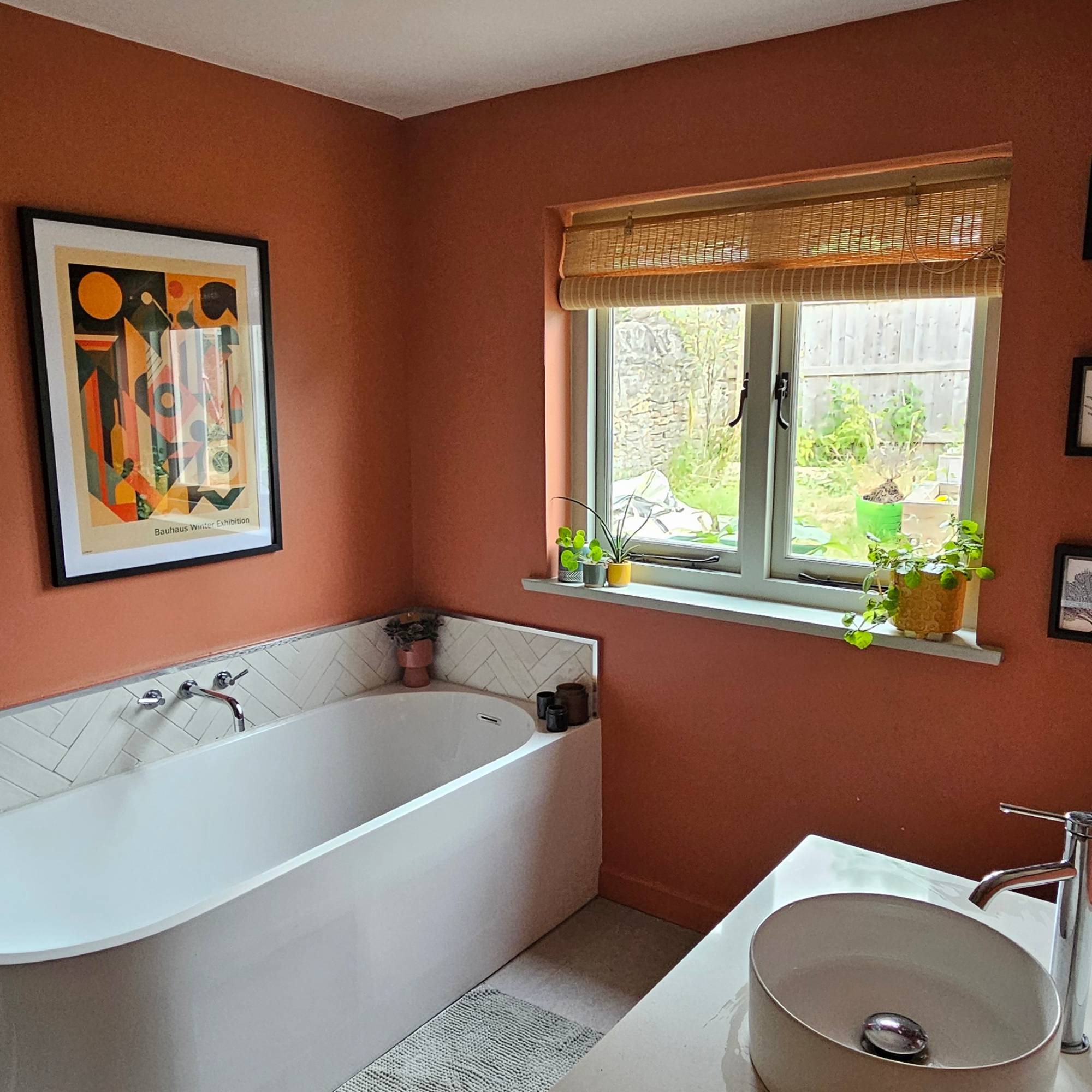 red bathroom with white tile and white bathroom suite