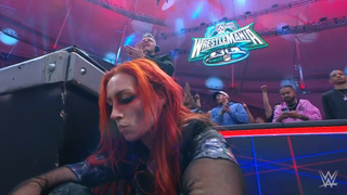 Becky Lynch looking dejected in front of the WrestleMania sign after losing The Royal Rumble.
