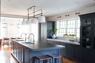 grey kitchen with wall sconces and kitchen island pendant lighting by Melinda Kelson