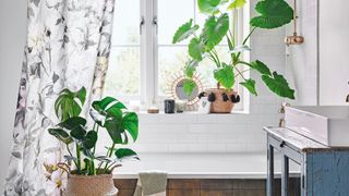 bathroom trend for plants surrounding bath with botanical shower curtain