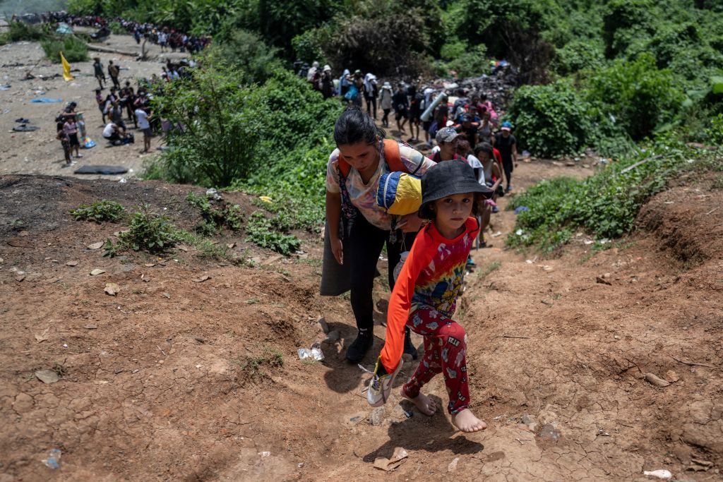 Migrants walk near the jungle in Bajo Chiquito Village.