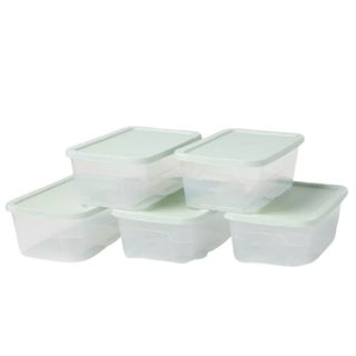 A pile of five storage containers with green lids