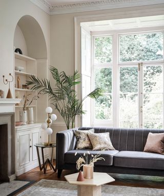A living room corner idea by Sofology with cream decor and 'shelfie'