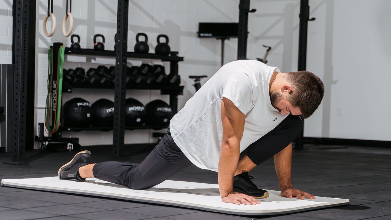 Pliability director of performance Cody Mooney demonstrating the dragon pose 