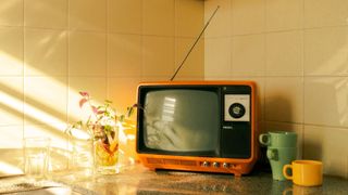 Black and white vintage TV in kitchen