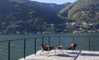 Two chairs and a table overlook Lake Como
