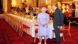 Queen Elizabeth II inspecting a banquet table