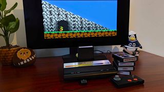 Atari 7800+ with Bentley Bear's Crystal Quest gameplay on monitor and cartridges on left next to controller