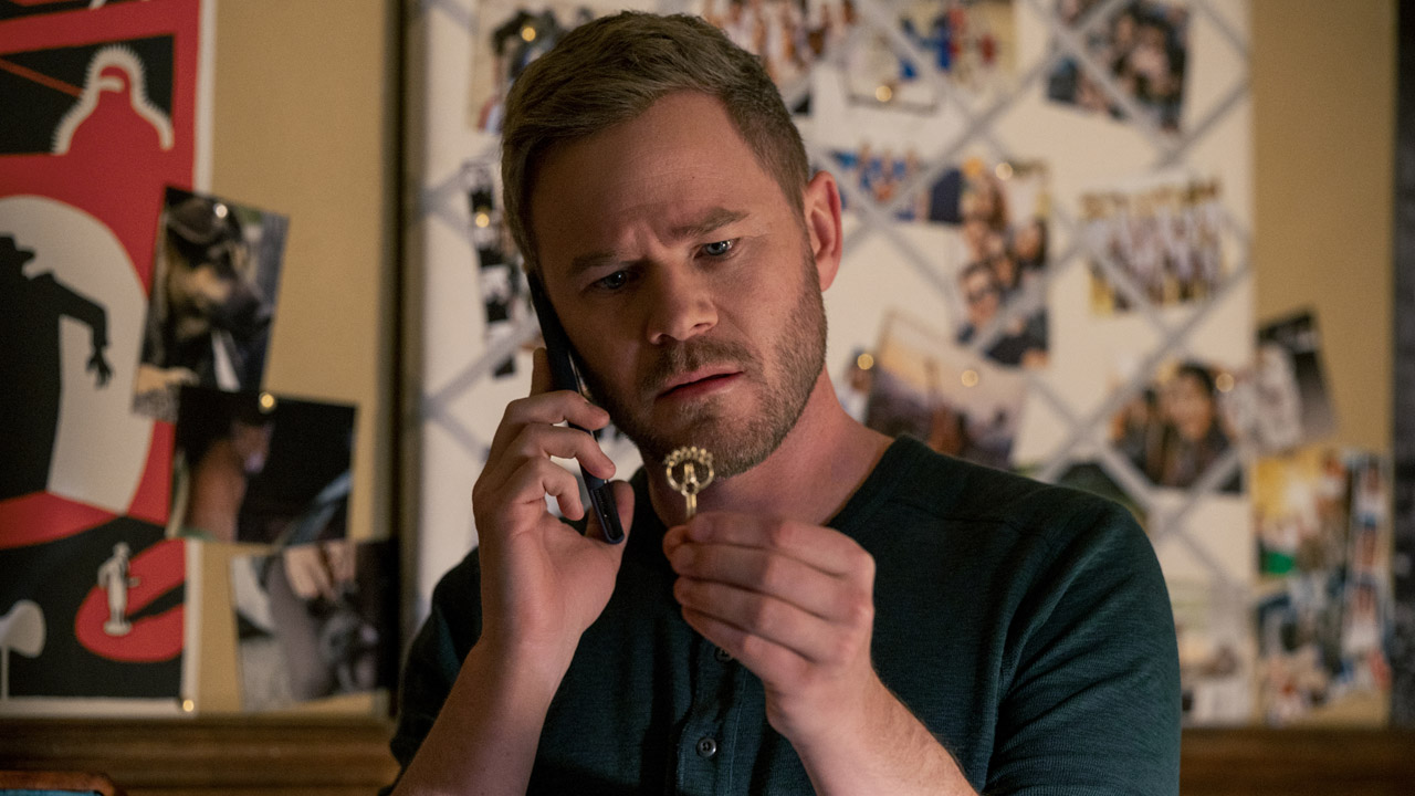 Duncan Locke examines a key in Locke and Key season 2 on Netflix