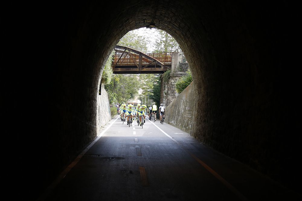 Teams ride through the tunnels along the narrow course