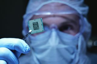 Stock image of a clean room operative holding a chip