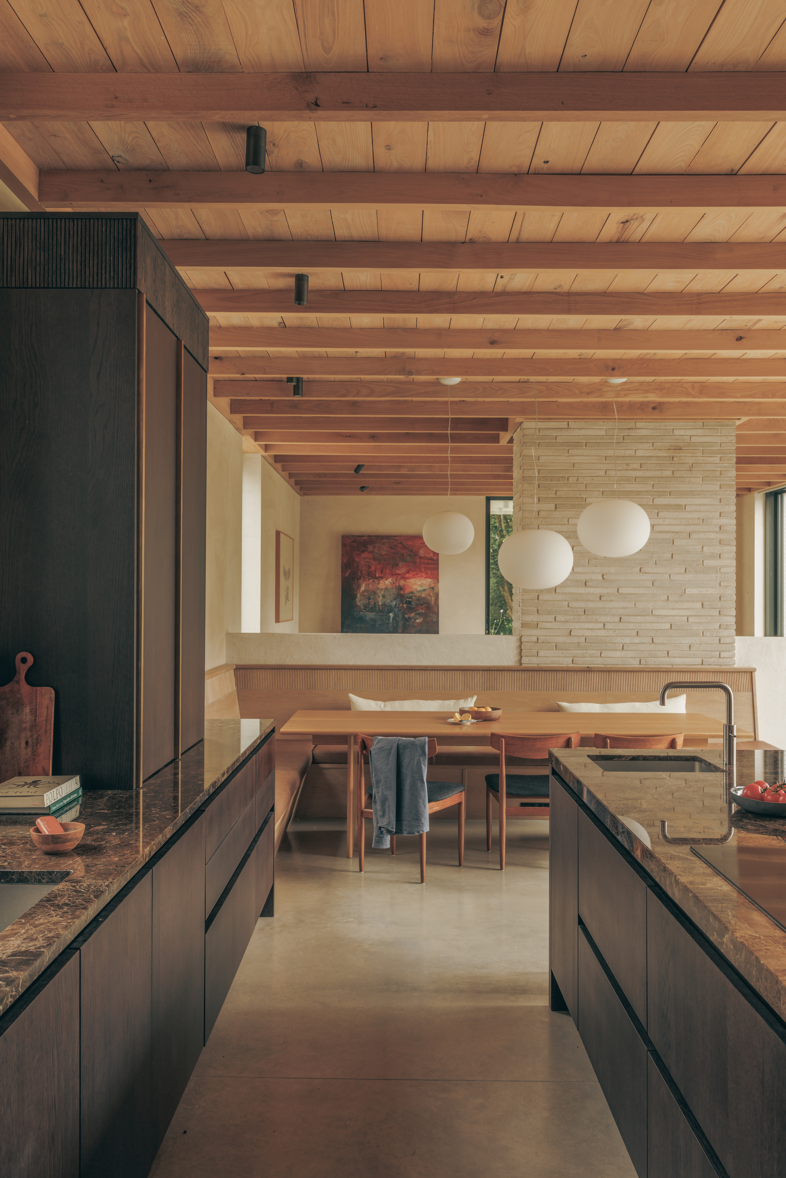 a modern, clean kitchen with wooden beamed ceilings and dark wooden cabinetry