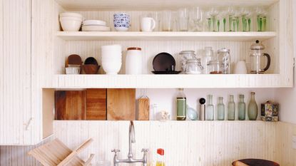 White kitchen shelves with plates and cookware
