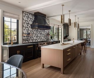 kitchen with wood island and contrasting cabinets geometric tile backsplash with wooden floor