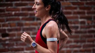 A runner wearing the COROS Heart Rate Monitor on her left arm.