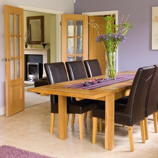 dining room with wooden door and dining table