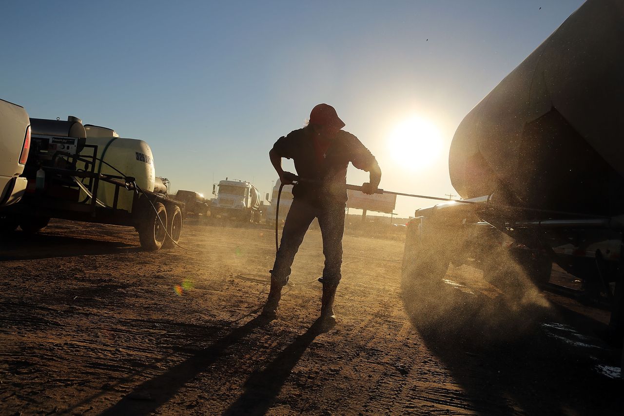 A truck used to carry sand for fracking is washed