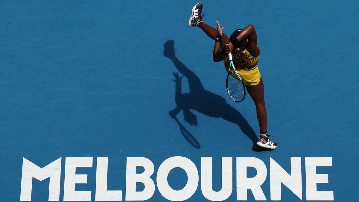 Coco Gauff of the United States plays an acrobatic forehand on a dark blue tennis court ahead of her Australian Open 2024 semi-final match featuring Gauff vs Sabalenka