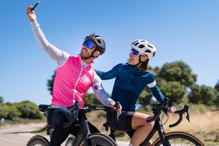 A cyclists taking a selfie and sharing their ride with a friend