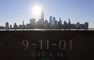 The sun rises above One World Trade Center and lower Manhattan in New York City on September 3, 2021 as seen from Jersey City, New Jersey.