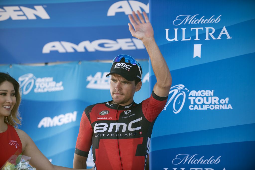 Greg Van Avermaet waves from the podium