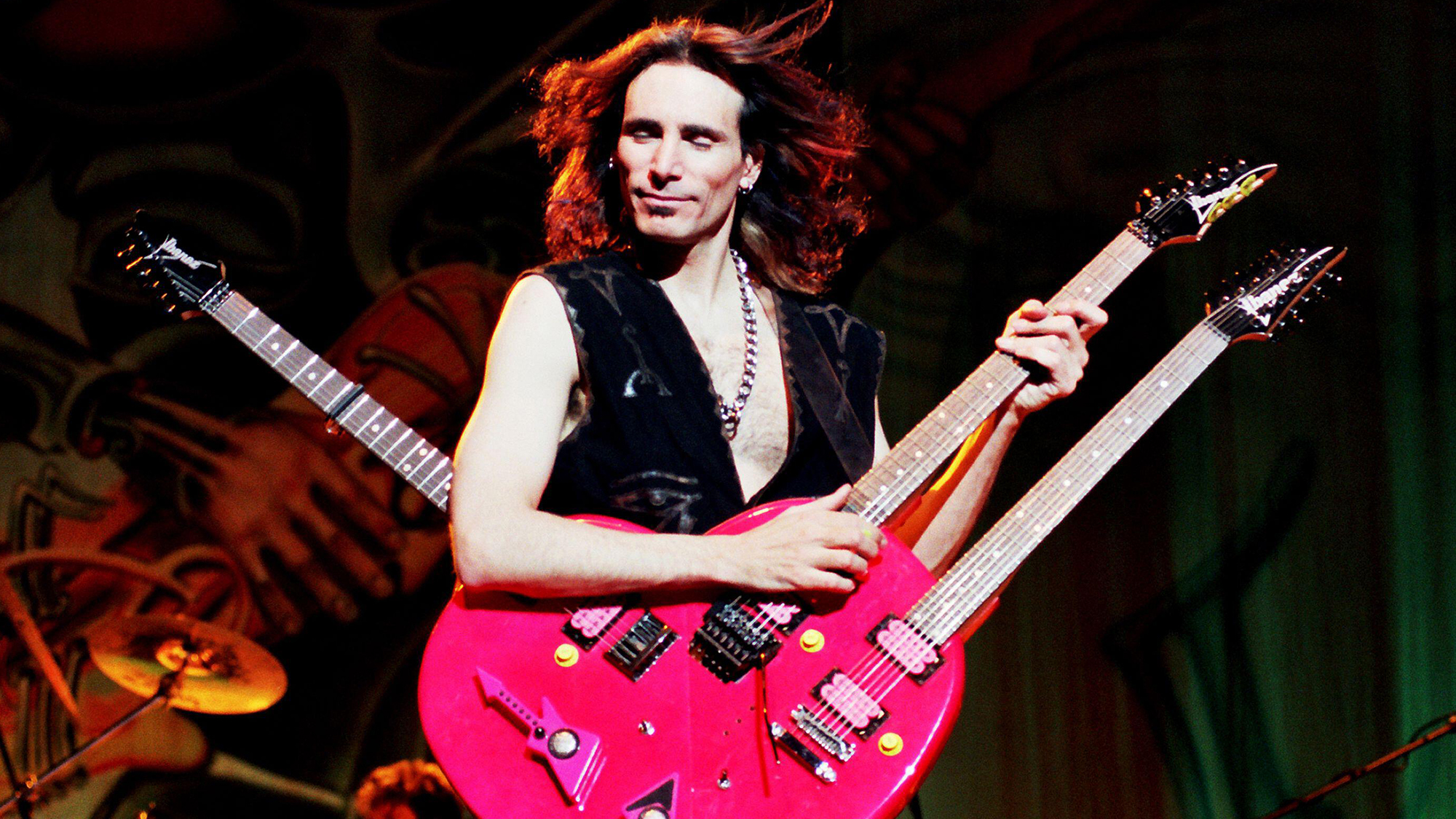 Steve Vai performing circa 1988 with his triple-necked Red Heart guitar
