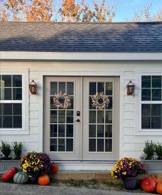 Fall porch decor with pumpkins and french doors with dried flower fall wreaths