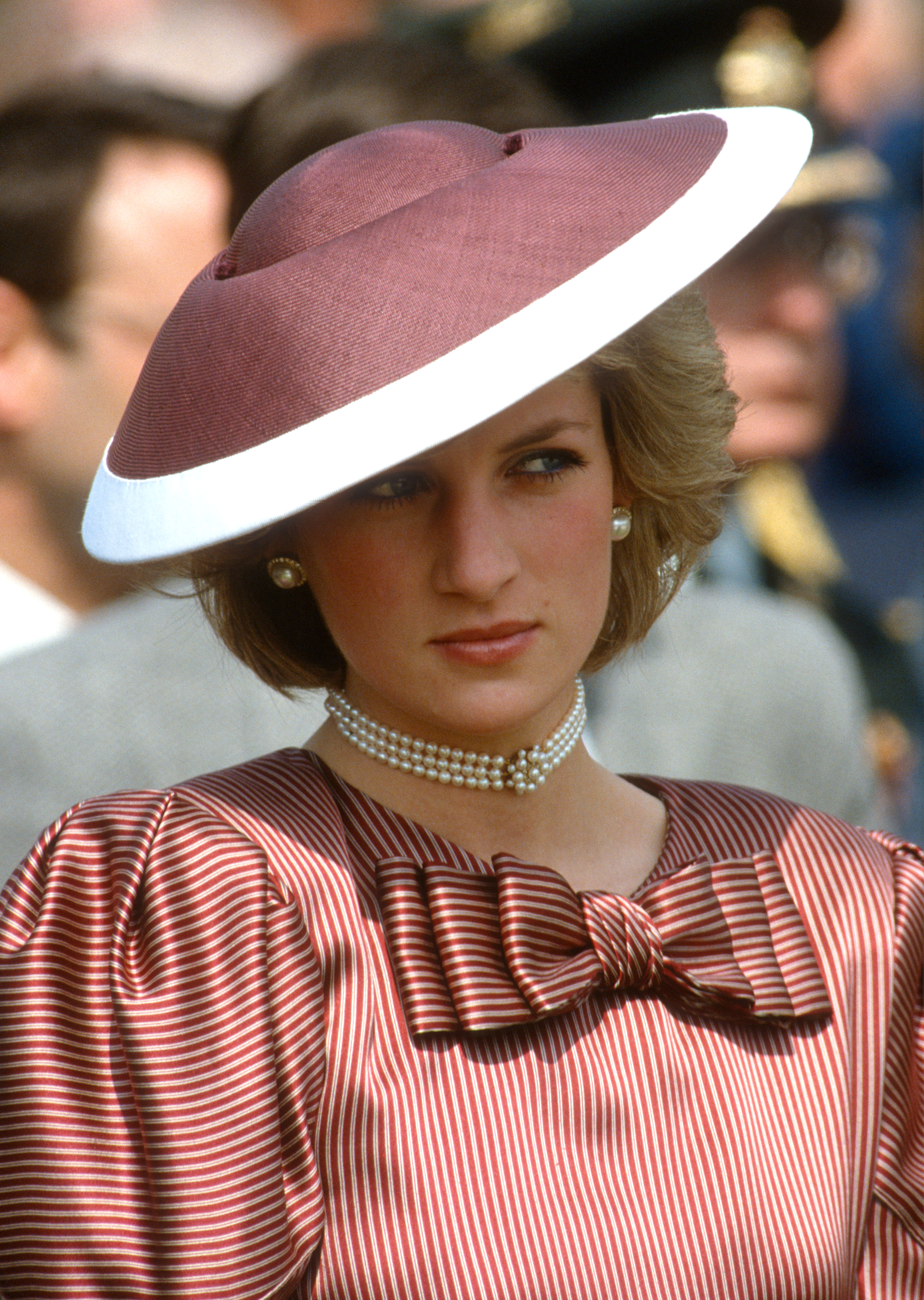 Princess Diana wearing a striped dress and mauve hat