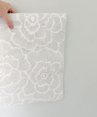 Floral peel and stick wallpaper decor against grey wall