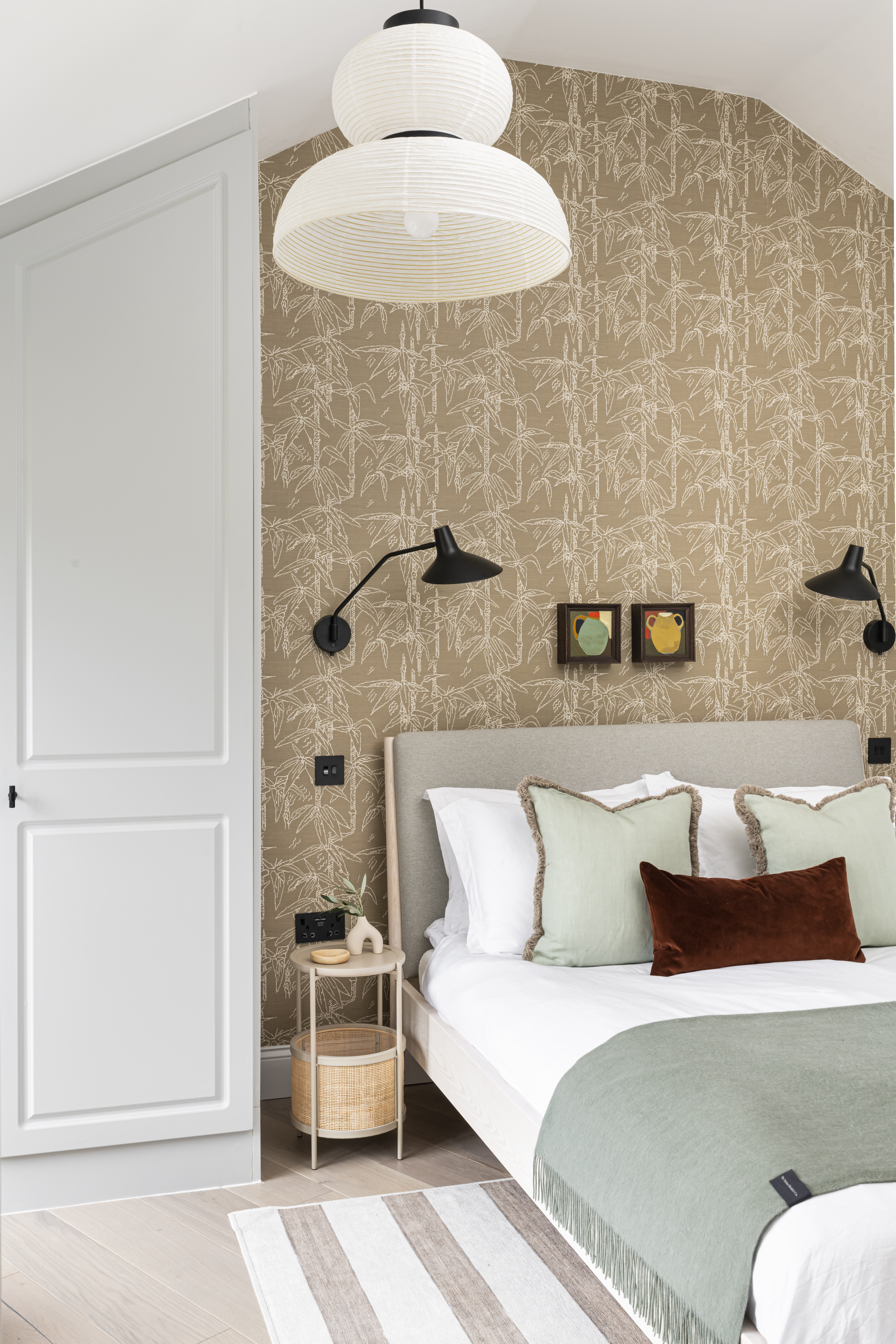 beige bedroom with pistachio green cushions and grey wardrobe by Interior Fox
