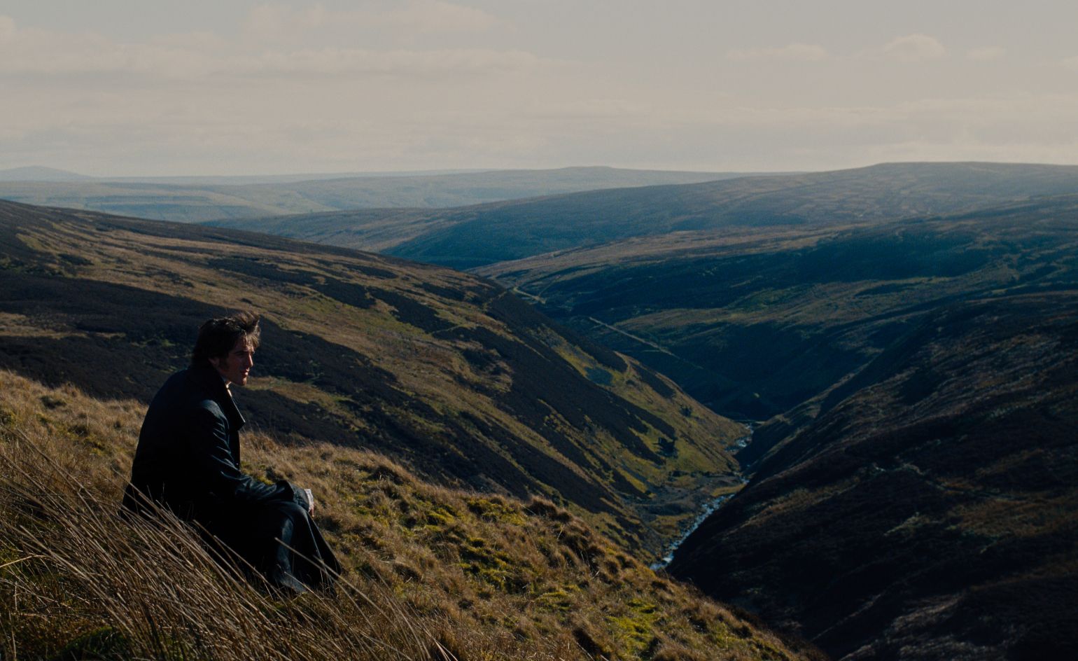 Still from Wuthering Heights with Heathcliff looking over Moors