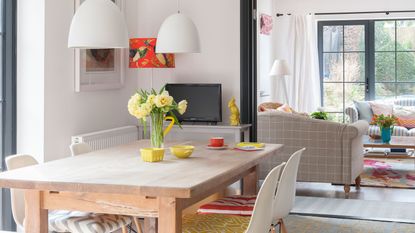 open plan living space with dining table and radiator