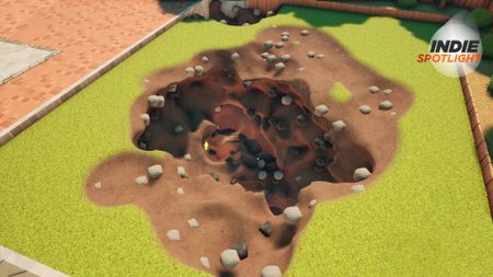 A large hole in a grassy garden with GamesRadar's Indie Spotlight logo in the corner