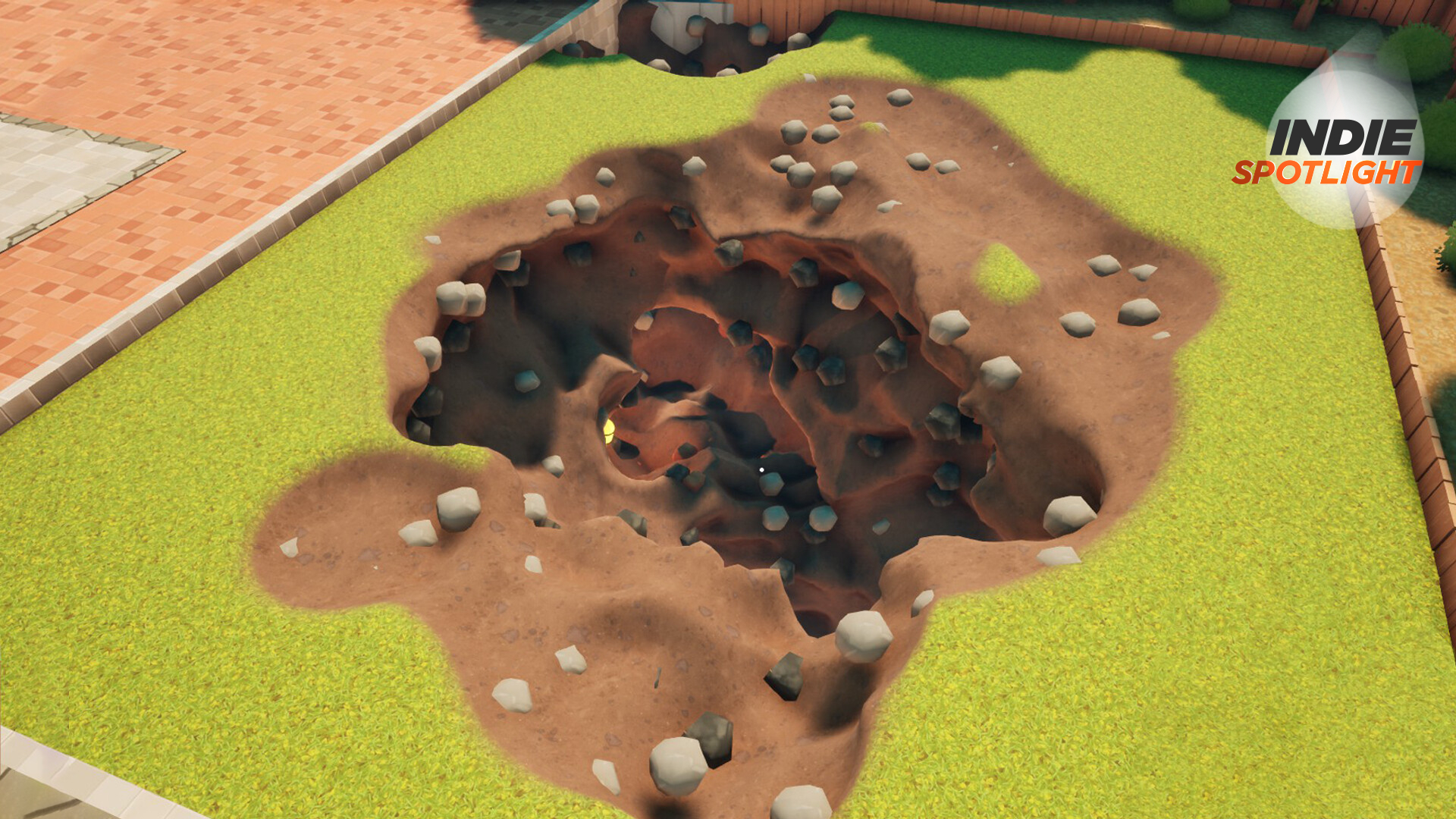 A large hole in a grassy garden with GamesRadar&#039;s Indie Spotlight logo in the corner
