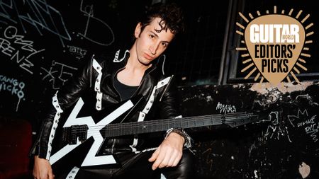 Des Rocs poses with his Aviator The Rocket electric guitar