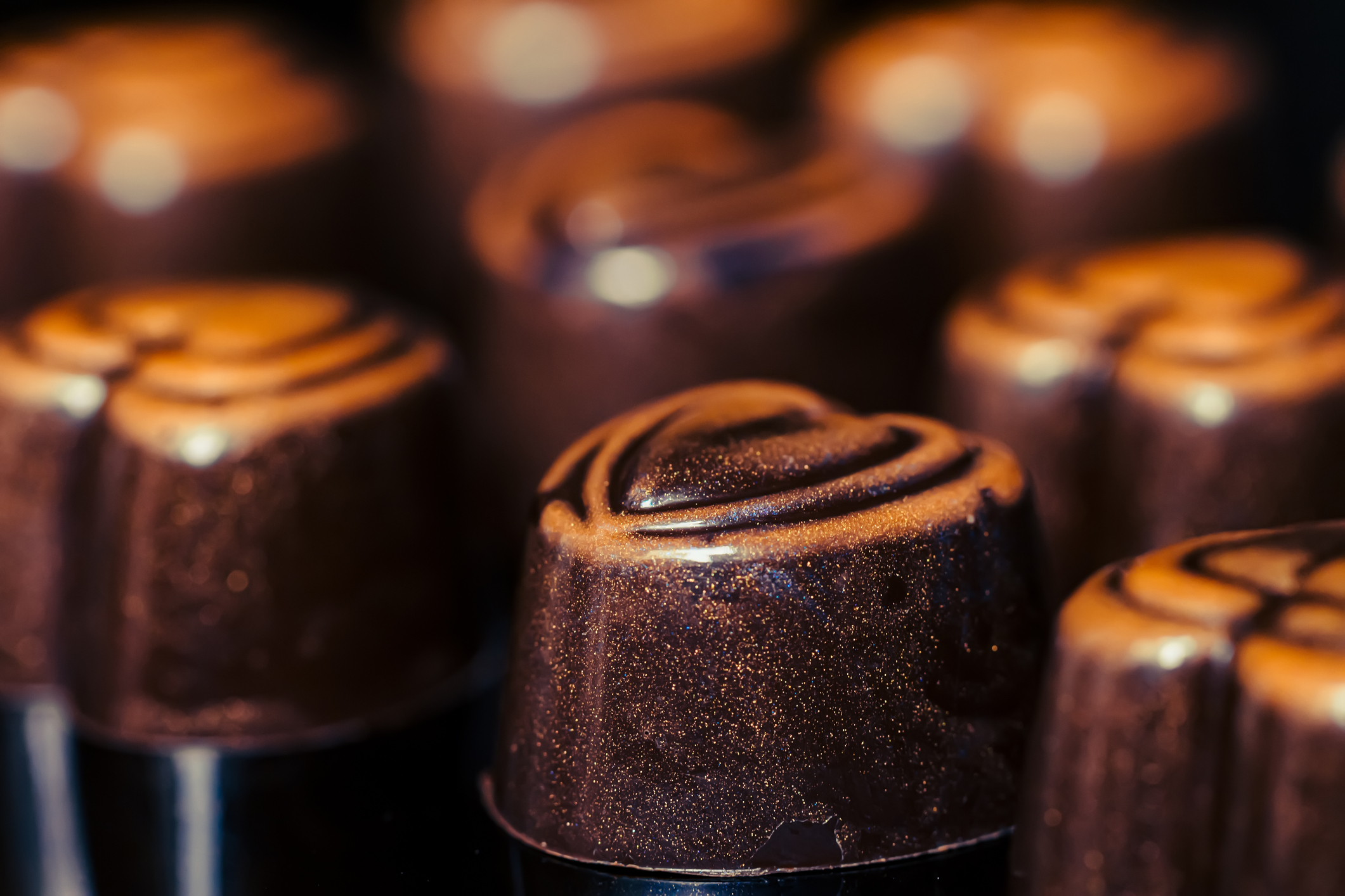 A close up of some heart-shaped chocolate truffles.